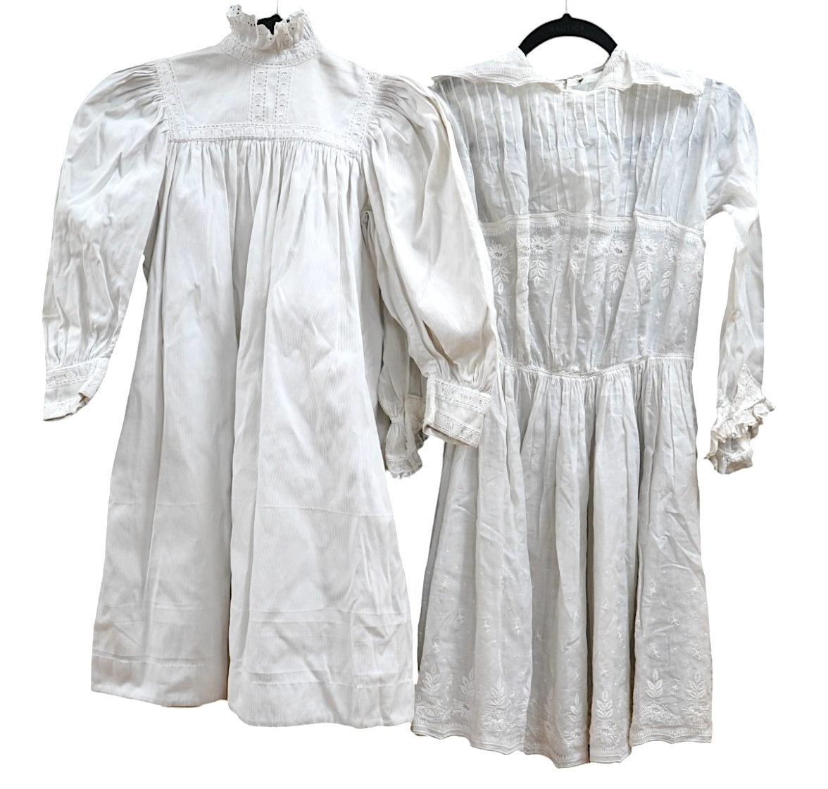 Two late 19th early 20th century girls summer dresses, one fine cotton with white worked collar cuffs and bodice, the other a cotton twill with anglaise collar large puff sleeves and gathered across the chest, lawn dress